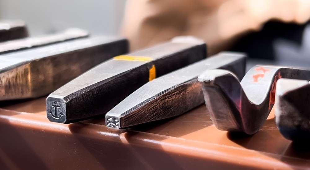 Hallmarking punches lined up showing the Anchor