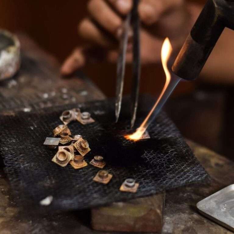 Image shows jewellery workbench and soldering silver